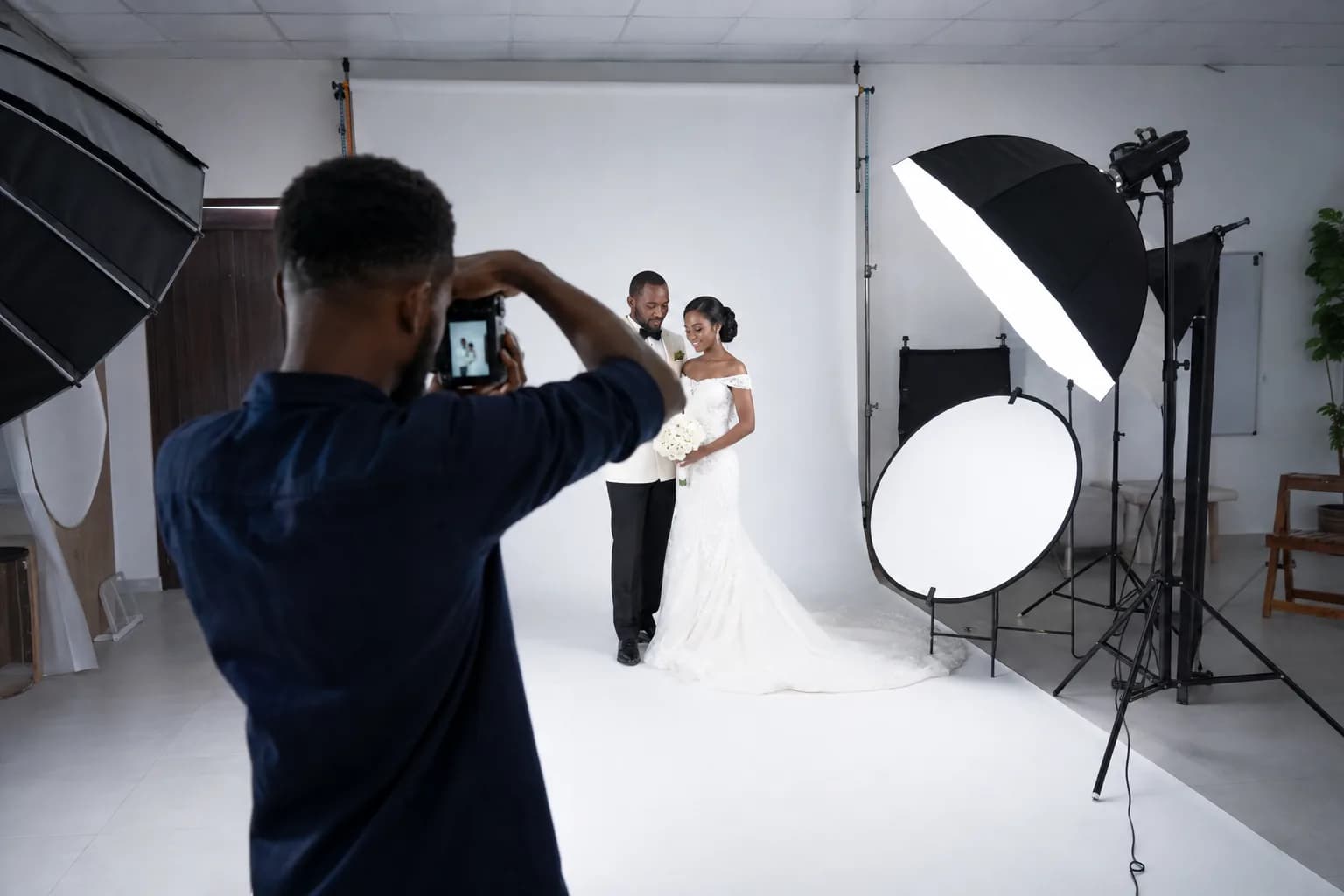 Photographer capturing a portrait subject in a studio